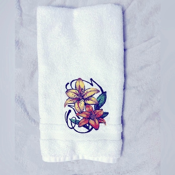 Floral embroidered hand towel featuring a pair of lilies. - Picture 1 of 3